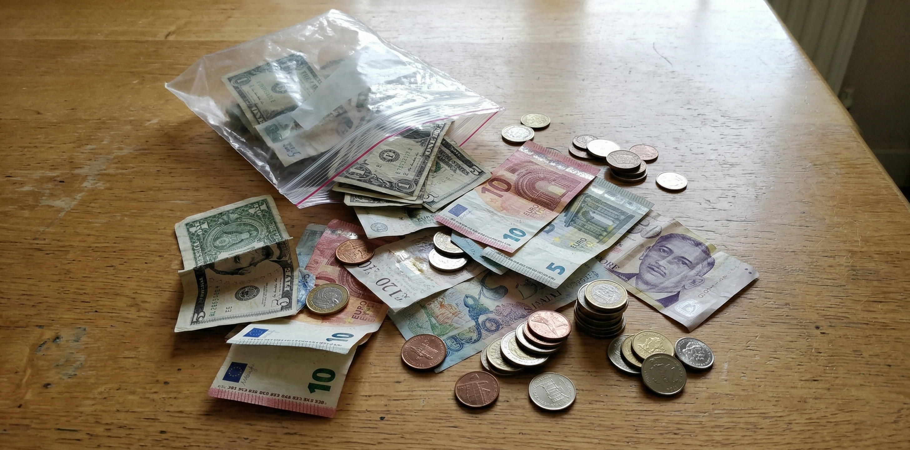 5カ国分の外貨紙幣と硬貨を並べた買取事例の写真